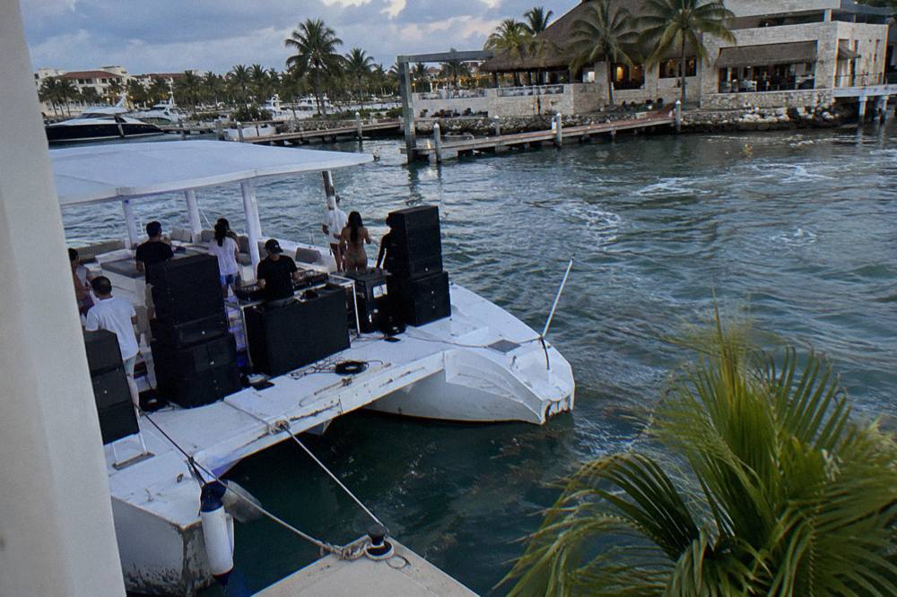 DJ booth and speaker stack on the deck of a party catamaran at sea
