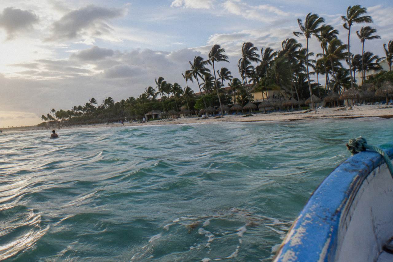 Decorated catamaran deck with balloons and palm-lined Punta Cana shoreline