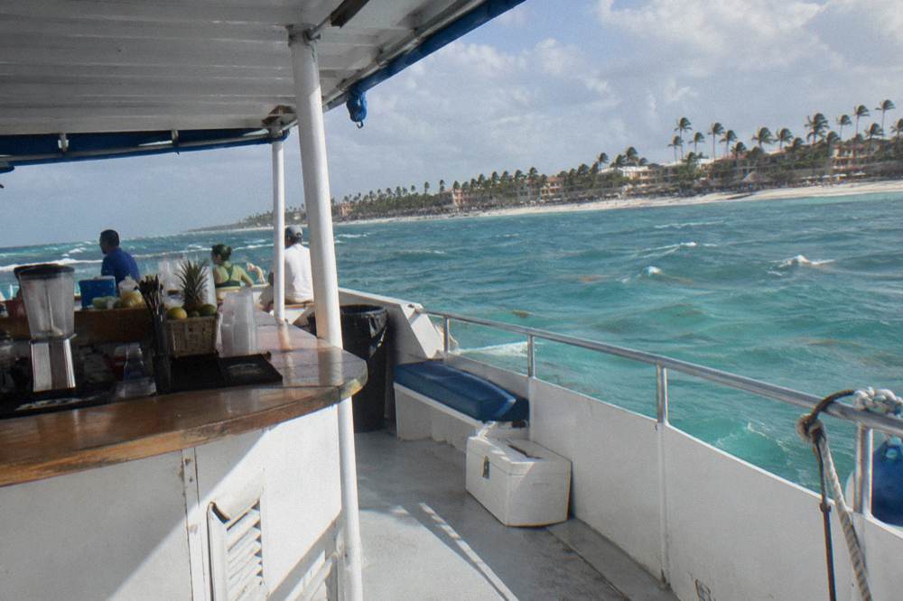 Bar area on a boat with cups lined up and crew serving drinks