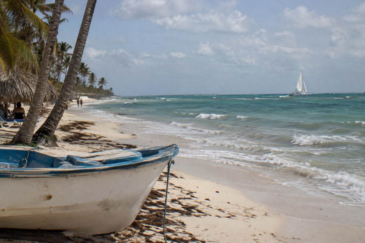 calm Caribbean water off the Bavaro coast with a catamaran sailing in the distance