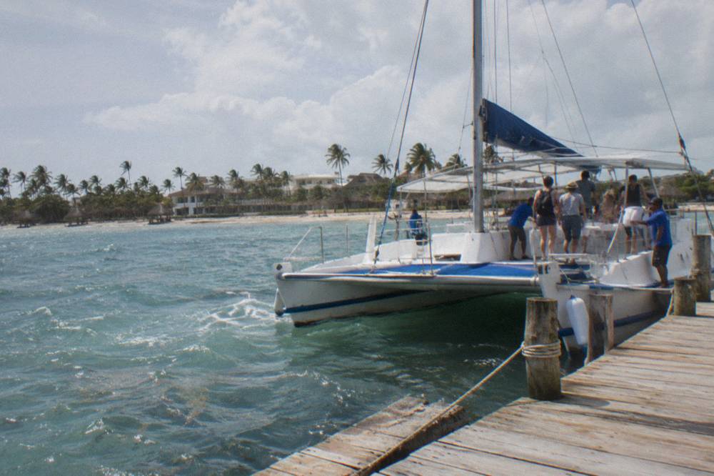 Catamaran passengers boarding at a Caribbean marina dock