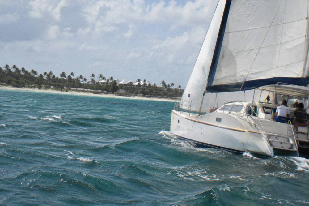 Catamaran sailing along the Bavaro coast on a sunny day with calm water