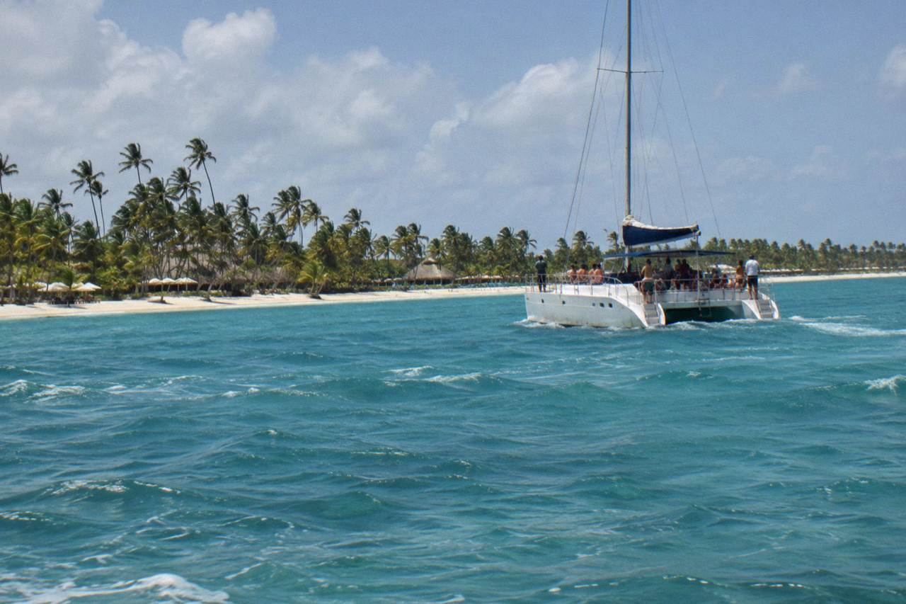 Catamaran deck with drinks tray and turquoise water near the Bavaro coastline