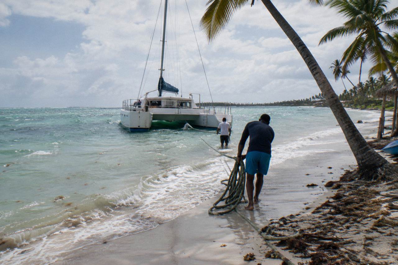 Catamaran moored at a Caribbean beach departure point with calm turquoise water