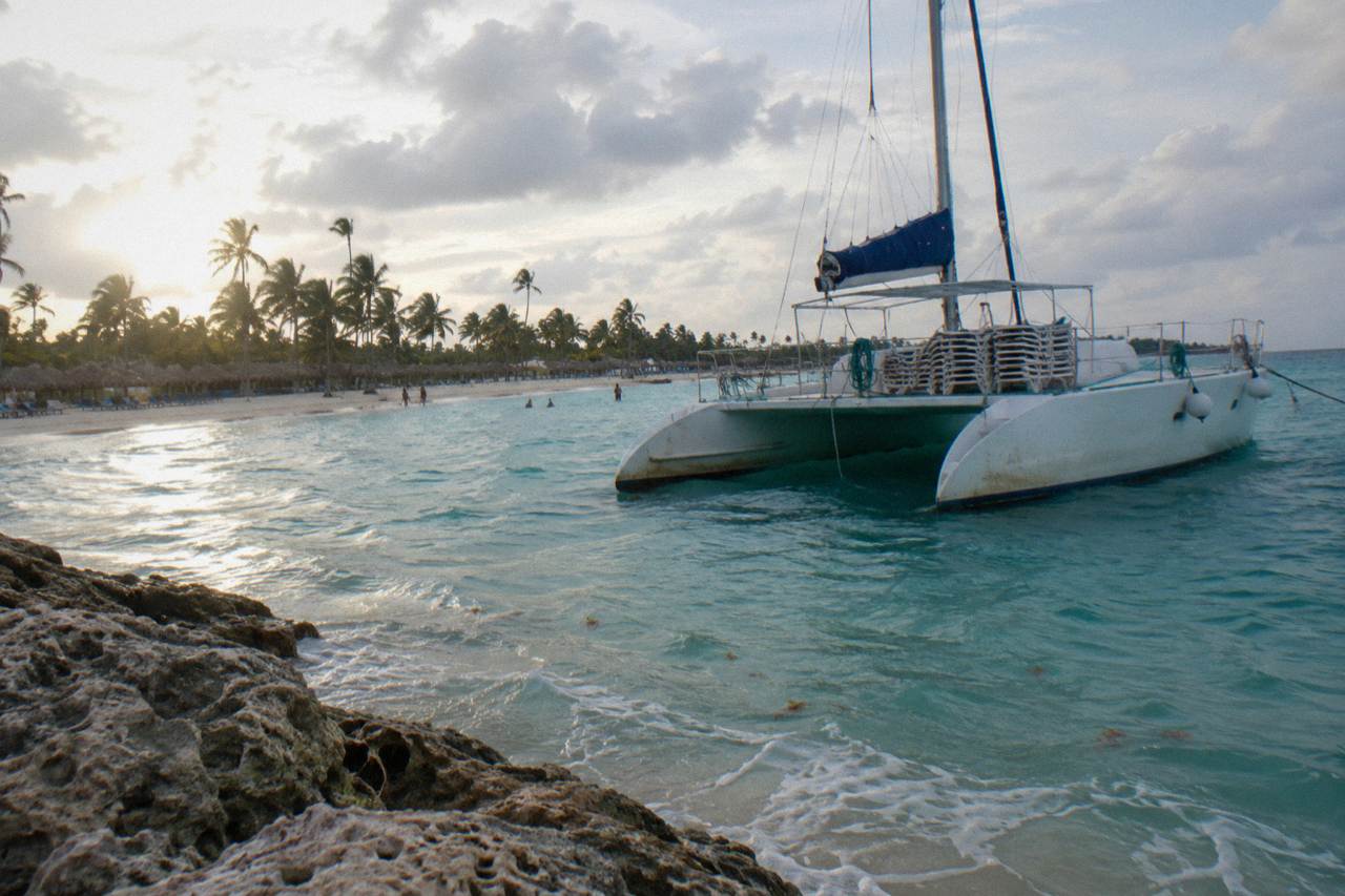 A catamaran anchored in calm turquoise water off the coast of Punta Cana