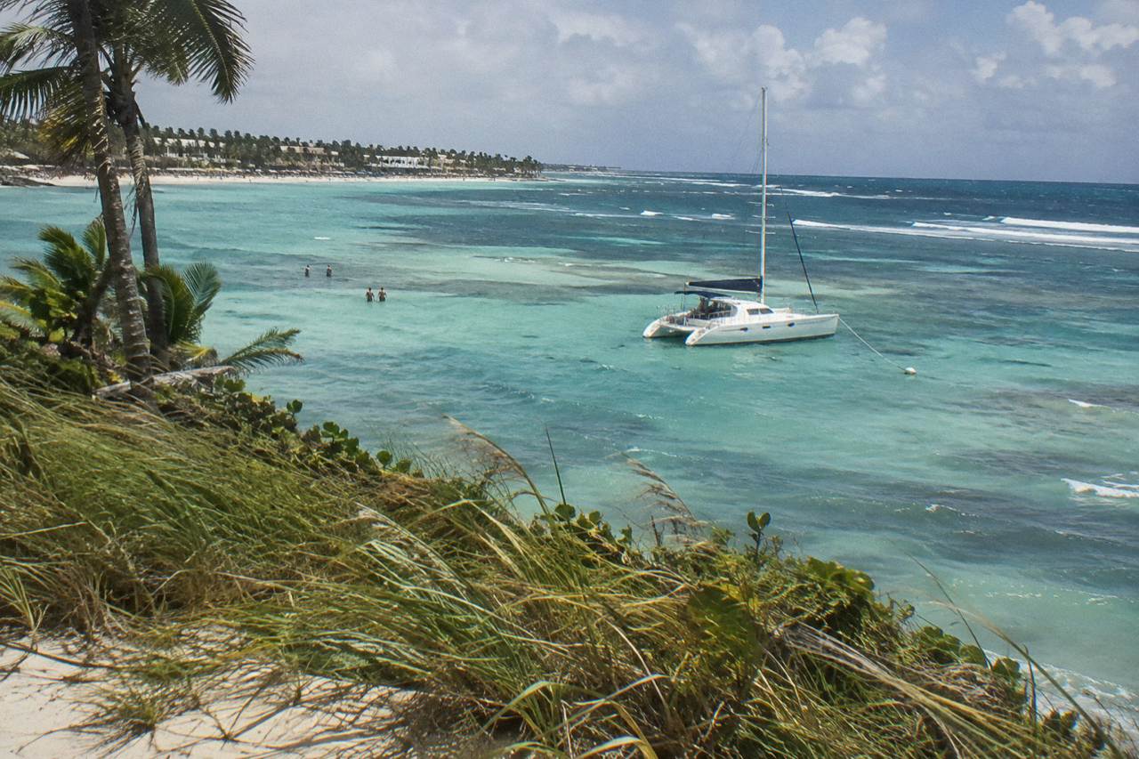 Private catamaran anchored in clear shallow water near the Bavaro natural pool