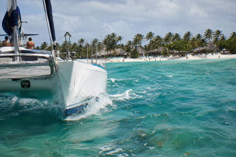 Catamaran bow cutting through turquoise water along the Bavaro coast