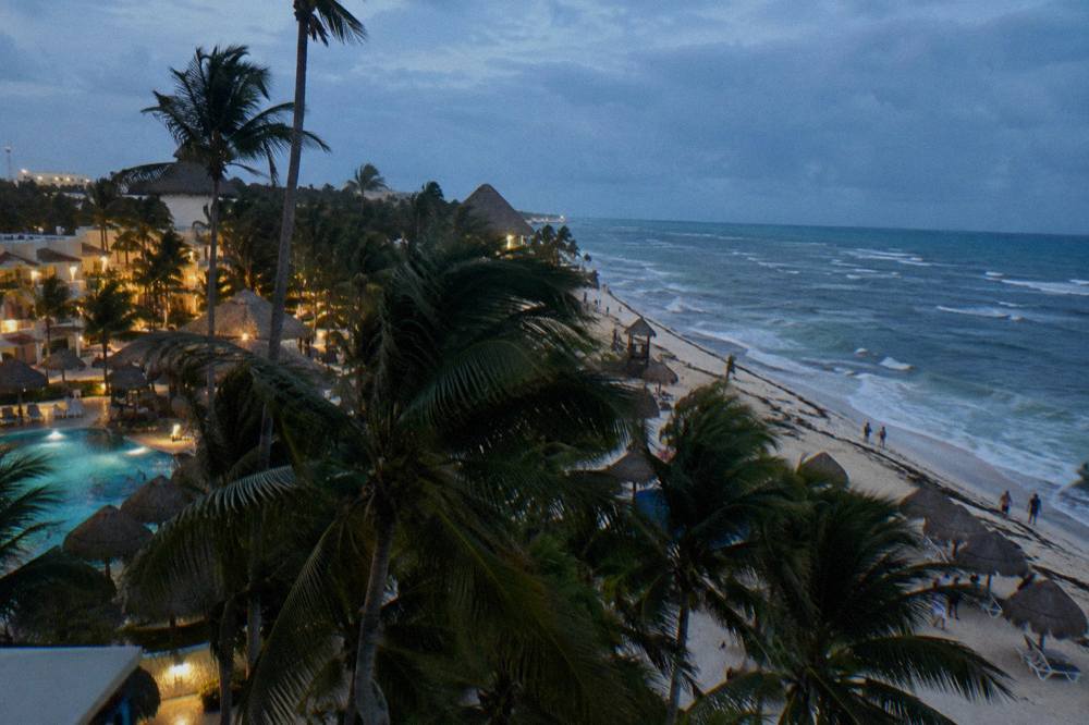 Evening view over palm trees and hotel lights along the Bavaro beach strip