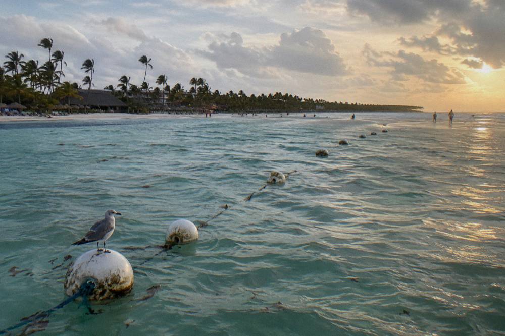 Buoy markers marking a navigation channel over shallow turquoise water near a sandbar