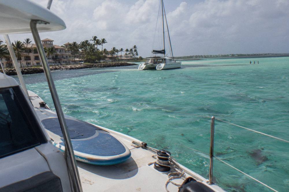 Catamaran anchored at a shallow sandbar with turquoise water in Bavaro