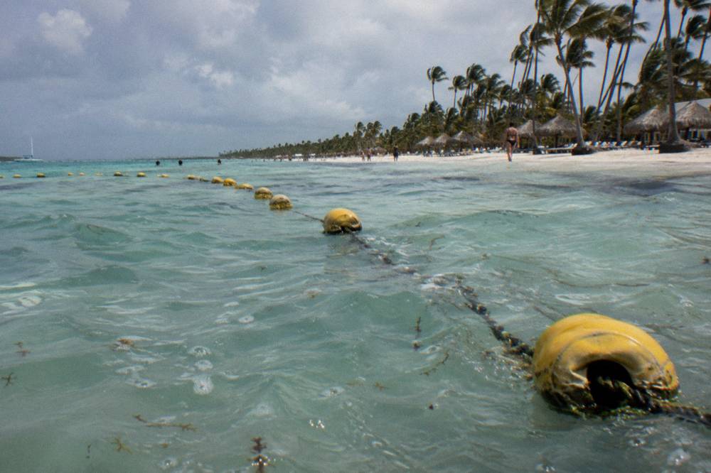 Buoy marker line marking a navigation channel over shallow turquoise water